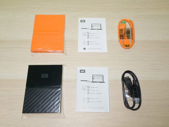 The contents of each box: the drive, the manual, and the USB cable.